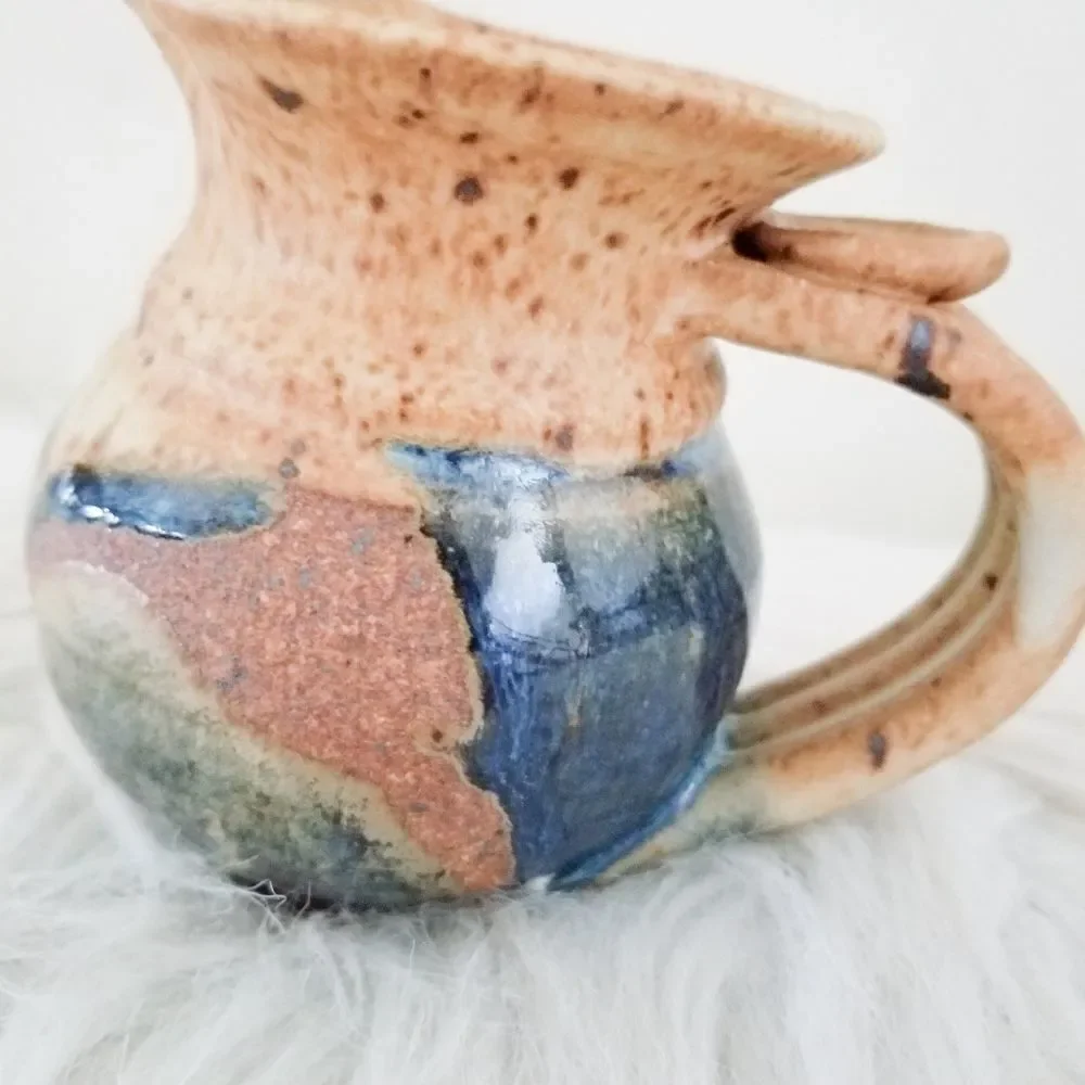 Pottery creamer signed by artist